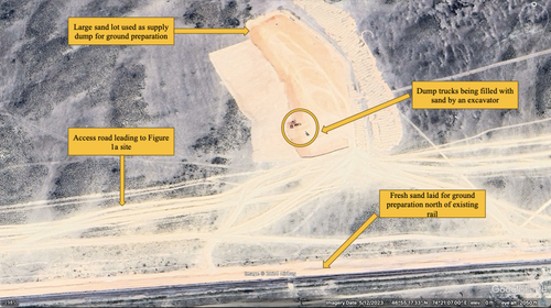 Google Earth imagery from May 12, 2023, showing a forward sandlot along the construction site, dump truck and excavators, and the access road. Coordinates 46°55'27.46